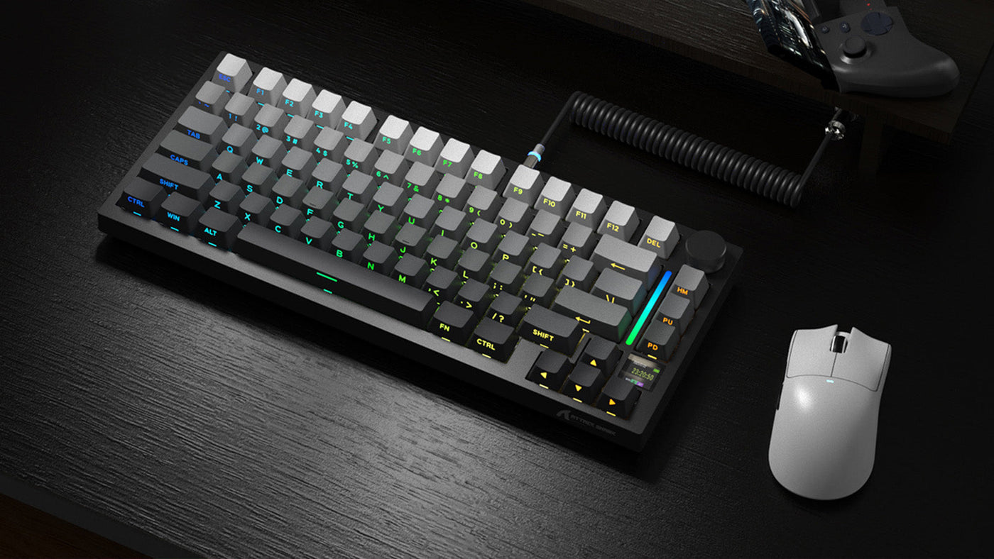75% layout dark grey mechanical keyboard with grey and white keycaps, a rotary knob, and a coiled aviator cable, placed on a dark desk next to a white gaming mouse.