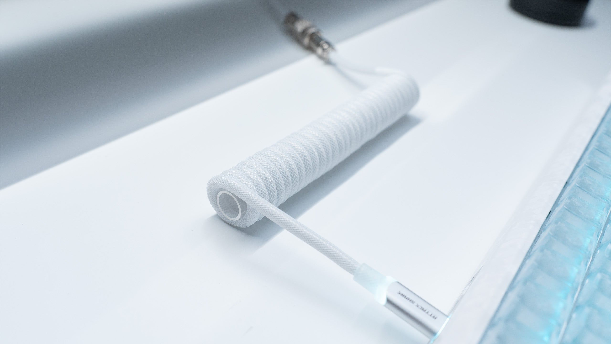 White coiled ATTACK SHARK USB-C cable with translucent connector and aviator plug